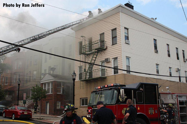 Firefighters and apparatus staged at the scene of a 5-alarm fire in Union City, New Jersey.