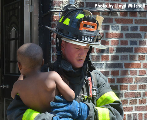 An FDNY firefighter brings down a young patient rescued from an apartment fire in Brooklyn, New York.