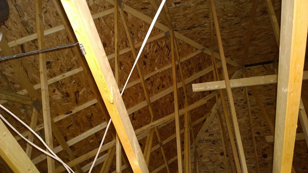 A photograph of the framing typically found in the gables of lightweight construction roof assemblies.  