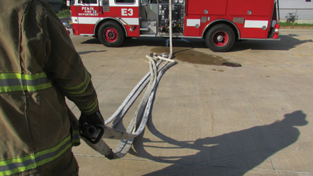 As long as the firefighter maintains the grasps on the loops and nozzle, the hose will stretch cleanly from the pile as the firefighter advances from the apparatus.