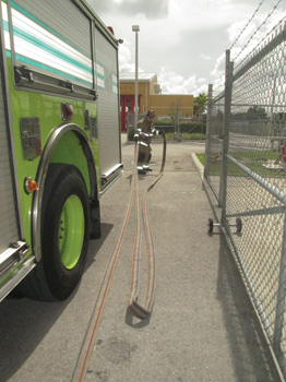 The nozzle firefighter stretches toward the point of entry (the rear of the apparatus.)