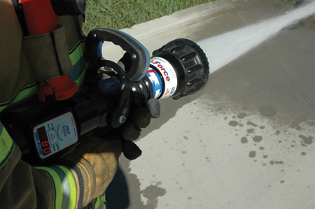 (1) The nozzle bail is fully open and flowing 140 gallons per minute (gpm) at 100 pounds per square inch (psi). <i>(Photos by author.) </i>(2) The nozzle bail is opened at around 50 percent and flowing 115 gpm at 100 psi. (3) The nozzle bail is opened at around 30 percent and is flowing 80 gpm at 100 psi.”></td>
</tr>
<tr>
<td align=