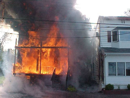 (3) Despite severe radiant heat, the aluminum-sided home on the right sustained very little damage; fire never extended to this home.