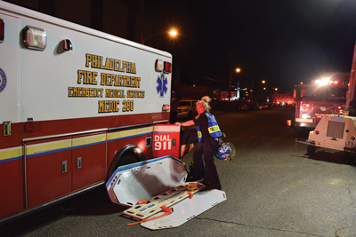 (7) Establishing a triage section was part of the initial incident strategy. Medic 22 members prepare to establish the primary triage area for the East Division on Wheatsheaf Lane. Usually, the senior paramedic on the first advanced life support ambulance is the triage group supervisor.