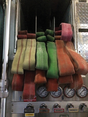 This is what a properly loaded flat load should look like when completed. Notice the two sets of pulling loops. These loops provide the option of pulling with one or two firefighters, depending on the situation. Make sure to have these loops on both sides, allowing for deployment from either side of the apparatus.