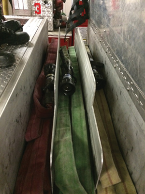 When completed, place the nozzles in the middle of the stack. Because the flat load can be pulled from either side of the apparatus, make sure to stay consistent in placing the nozzles in the middle so that the firefighters can easily find them and control them as the line is deployed.