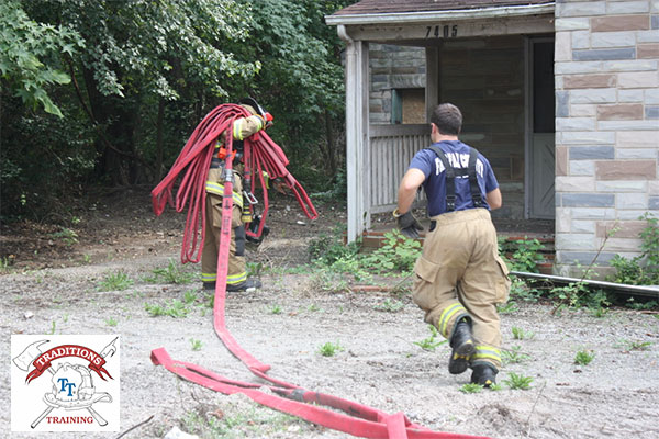 A firefighter flakes out a hoseline.