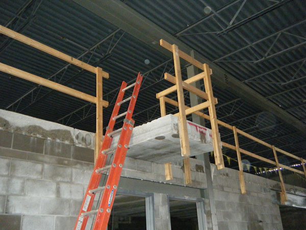 A ladder that is in place for access to and evacuation from an industrial mezzanine.