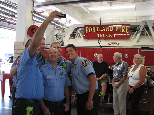 Portland (OR) firefighters take a "selfie" with Ethan Reed at his retirement party