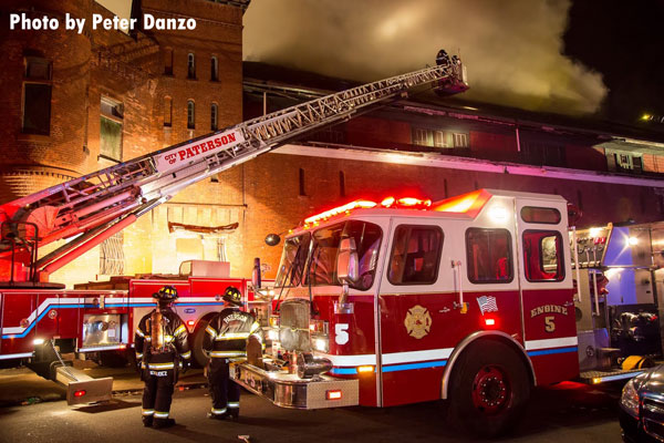 Multiple firefighters and apparatus on scene at a 7-alarm Paterson (NJ) fire.