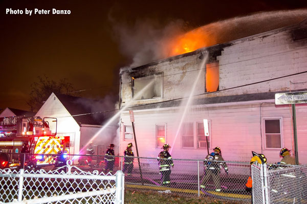 Firefighters use two handlines on the exterior of a dwelling fire in Belleville, New Jersey.