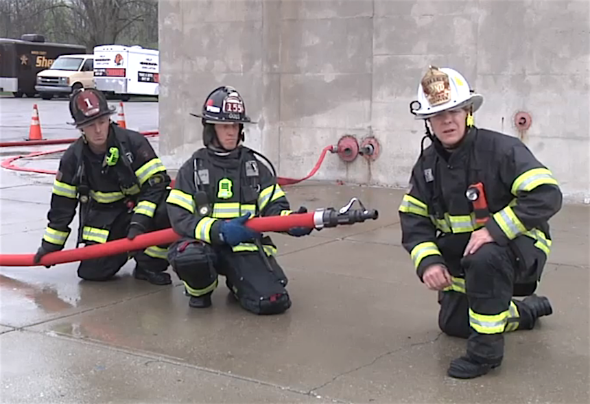 Dave McGrail with firefighters on a hoseline