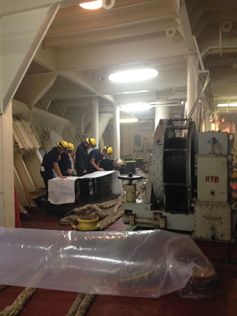 Technician-level firefighters and officers must understand vessel construction and layout completely. Here, a chief officer and crew determine how to best ventilate a space using the ship’s fire control plan.