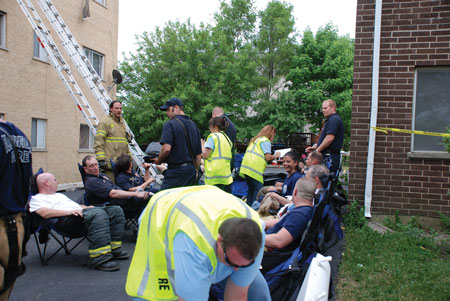 (3) Firefighters undergo rehab at an extra-alarm apartment fire. <i>(Photo by Diane M. Zaccard.)</i>