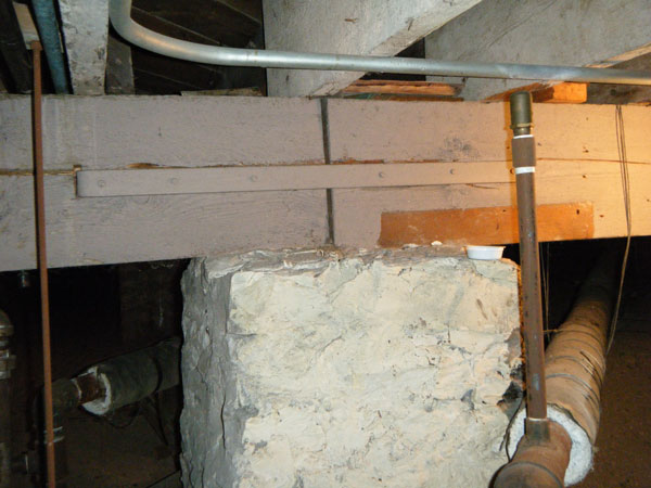 Photo 2 shows a view of a crawlspace under a heavy-timber church built around 1895.