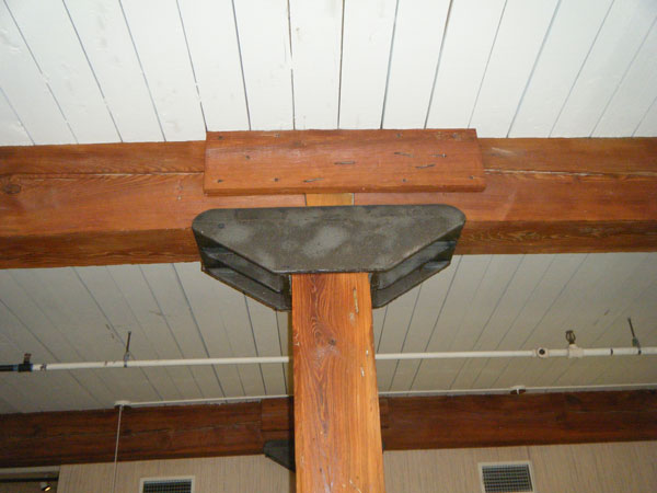 Photo 5 shows a column and beam in a mill construction building constructed in the early 1880s.