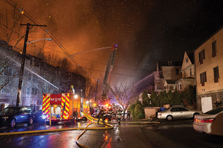 (4) Note the embers generated by the large body of fire. Several of the buildings on the right in the photo were damaged or destroyed during a fire in 2000.