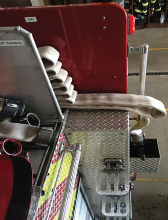 (2) This view shows the bottom loop, which acts as a “tray” for pulling the 100-foot stack from the hosebed and down to the firefighter below for deployment. The loop is not there to put your arm through but rather to bring the stack forward for ease of grabbing it from the rear of the hosebed. 