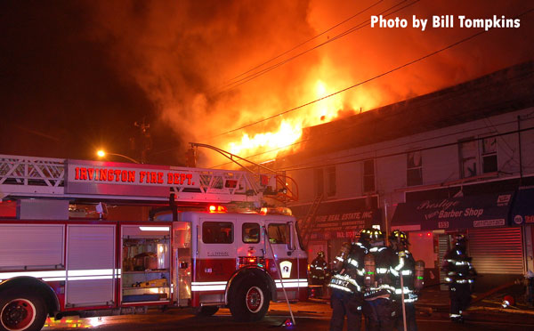 Firefighters at the scene of an Irvington (NJ) fire that tore through several busnesses and apartments.