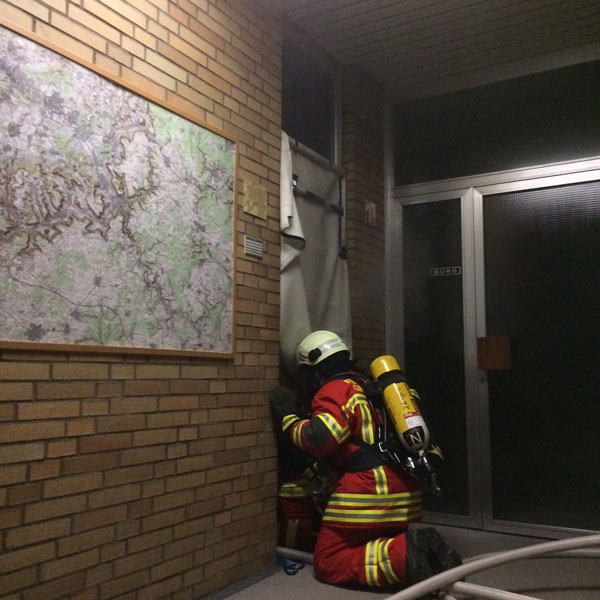 A firefighter making entry to the compartment.