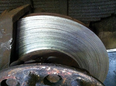 (15) Driving with disc brake pads that are completely worn out causes serious scoring of the brake rotor.