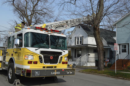 (1) When approaching the scene, be aware of trees that may hamper placement of the aerial. Also position apparatus out of the collapse zone. <i>(Photos by Don Murtha III)</i>. 