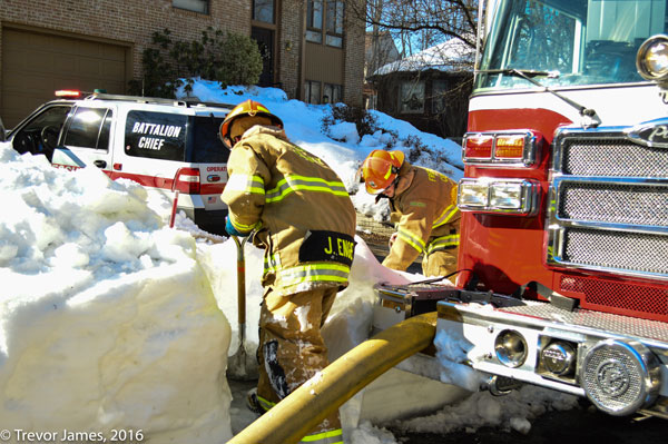 A firefighter clears a hydrant during a fire in New Market, Maryland.