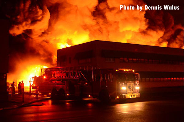 Fire apparatus at the scene of a raging warehouse fire in Highland Park, Michigan.