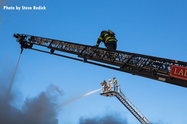 Firefighters operating at the scene of an apartment fire in Glenwood, Illinois.