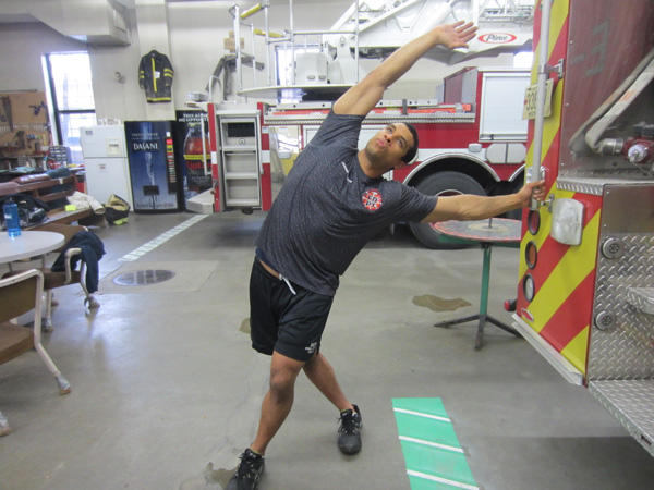 Jordan Ponder performs a stretch on the rig to alleviate low back pain.