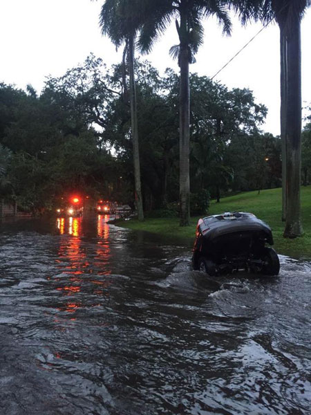 Scene of a partly submerged vehicle where a woman was rescued by firefighters during flashing flooding in St. Petersburg, Florida.