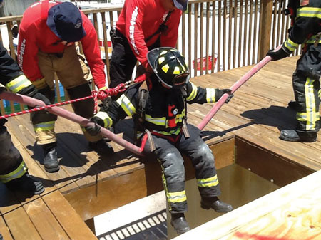 (6) A rescuer is being lowered into the hole during the Nance Drill. <i>(Photo courtesy of Mark Rossi.) </i>