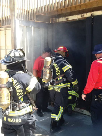 (8) The air-consumption prop is a survival prop built to mentally and physically challenge the firefighters in a dark and confined space. Crews work together in teams of three to search a collapsed structure and then exit the prop through hurricane-enforced glass. (Photo courtesy of Mark Rossi.)