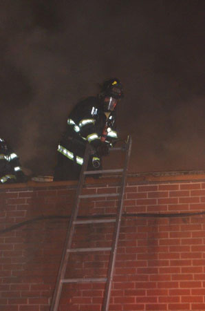 (6) A member operating on the setback’s roof ensures that the ladder is secure. If members are moving the hoseline, someone needs to protect the ladder as the primary means of egress. 