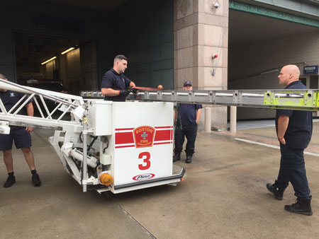 (8) You can place a portable ladder across the top rails of this bucket with front-opening doors. You can also place another ladder on the brackets, enabling you to deliver two ladders at one time. 