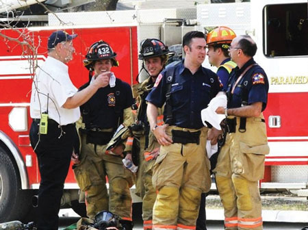 (3) LFD Chaplain Kenneth Wells (left) visiting with a Flower Mound (TX) Fire Department crew at the scene of a structure fire. (Photo by Sheri Baldwin.)