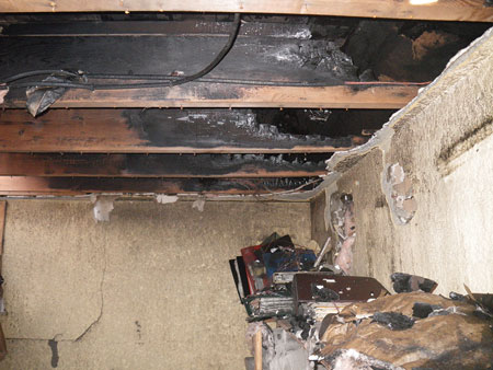 (3) Burn patterns in a flat roof joist space after a three-story apartment fire. Dimensional lumber used in flat roof construction is common to modern and older buildings.