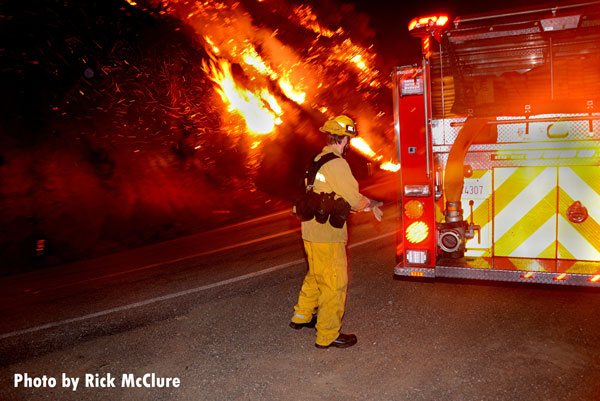 A firefighter operates in the fire area.