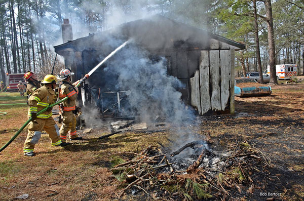 Firefighters hit the exterior of a burning structure in Salem, North Carolina.