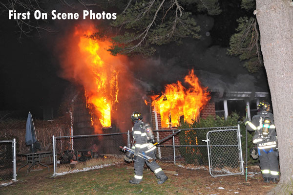 Firefighters operate at the scene of a house fire in Franklin Square, New York.