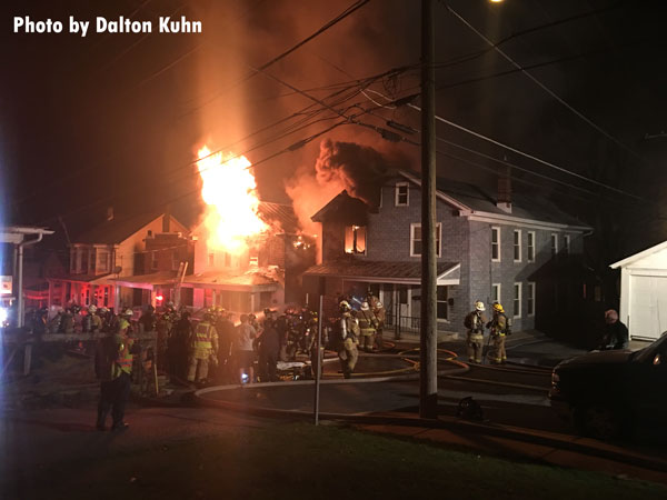 Flames erupt from a residential structure during a fire in Ephrata, Pennsylvania.