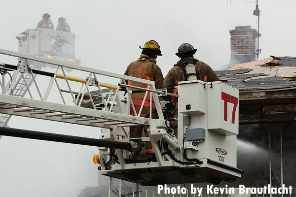 Buffalo firefighters in a tower ladder bucket at a recent three-alarm fire.