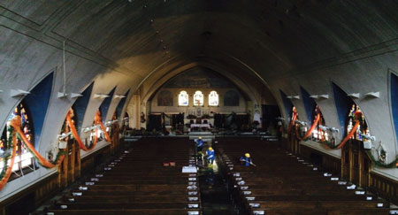 (1) A view of the nave from the choir loft. Note the walls are sloping toward the ceiling and there are numerous stained-glass windows. Firefighters operating on the nave may not be aware of conditions above since the ceiling may be 30 or more feet high. Venting of these expensive windows will not alleviate a smoke condition in the upper portion of the church. (Photos by author.)