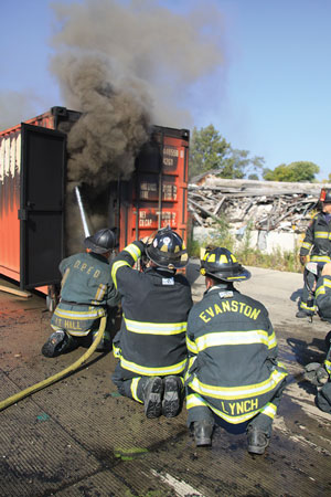 (1) Instructors review modern fire behavior principles using hands-on demonstrations. Participants were able to observe uni- and bi-directional flows, neutral plans, and gas cooling. <i>(Photos by Tim Olk.)</i> 