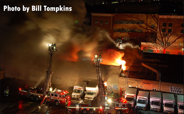 Flames erupt from the roof of a building in Brooklyn, New York.