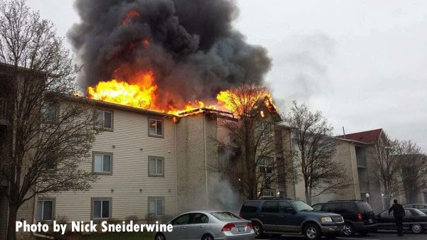 Flames shoot from the roof of an apartment complex in Merrillville, Indiana.