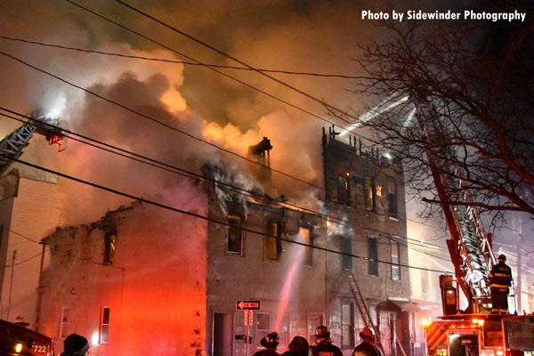 Firefighters use master streams to try to control a raging fire in the city of Cohoes.