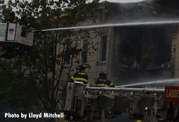 Tower ladders operating at the scene of a gas explosion that collapsed a three-story building in Brooklyn.