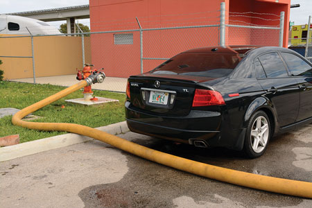 (10) A four-way valve improvises as an elbow to reroute the supply line around the vehicle blocking the hydrant. 