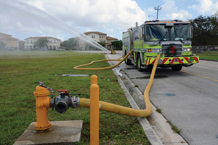 (20) A short section of five-inch hose connects the engine to a hydrant.